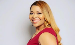 a photo of a smiling woman in red dress