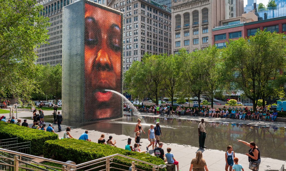 Families and kids enjoying the splash pad at Crown Fountain in Millennium Park, a top summer spot for splash pads in Chicago.